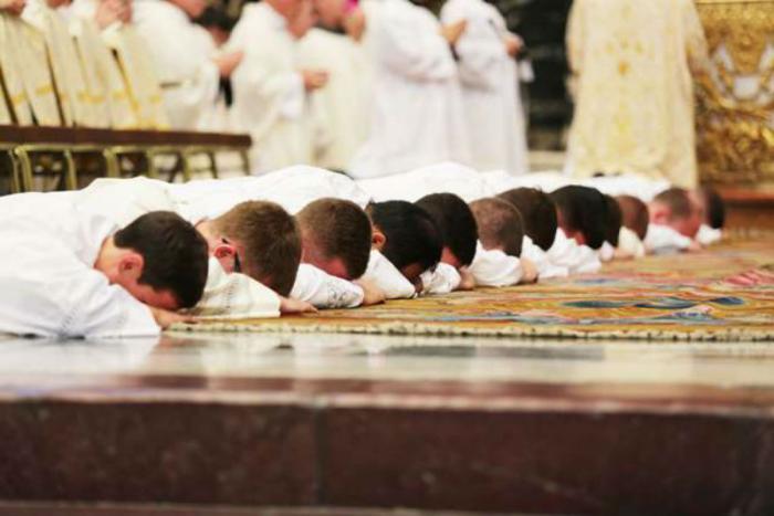 Ordinandi lay prostrate during the Litany of Saints during an Ordination Mass in St. Peter Ordinandi lay prostrate during the Litany of Saints during an Ordination Mass in St. Peter