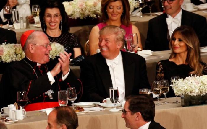 Cardinal Dolan sits beside Donald Trump at the 71st annual Alfred E. Smith Memorial Foundation Dinner in New York City.
