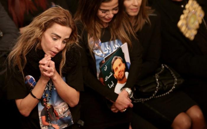 Sisters of Elias Wardini, a Lebanese man killed in a gun attack on the Reina nightclub in Istanbul, mourn during his funeral Mass at the Church of Our Lady in Beirut.