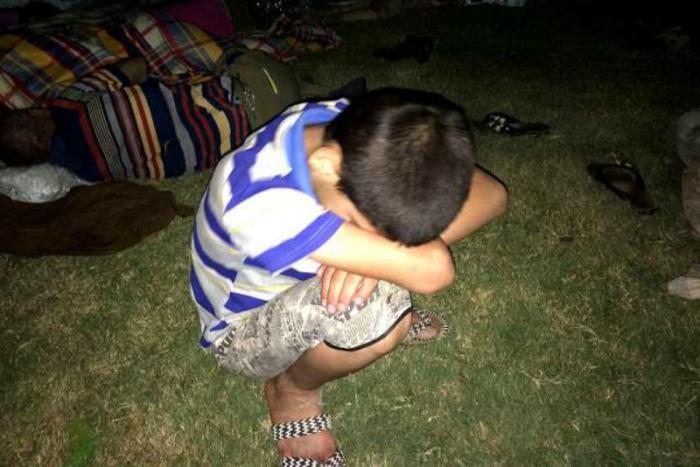 A young refugee rests after having fled from ISIS and arrived in Ankawa in the northern part of Erbil, Iraq.