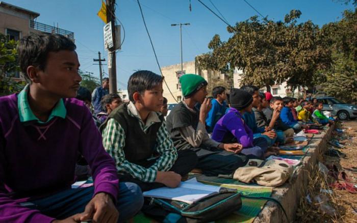 Children are so desperate to learn they attend classes on the side of the road.