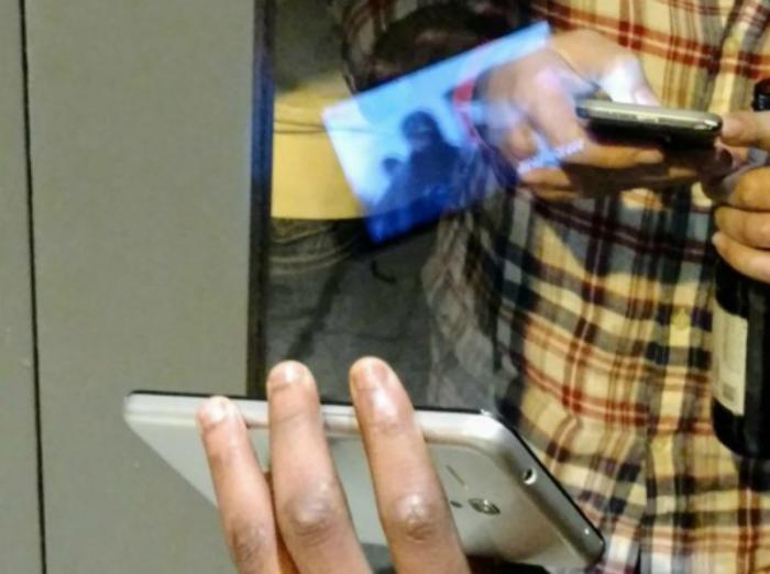 The man showed an image of the ISIS flag then a portion of an ISIS propaganda film. The man showed an image of the ISIS flag then a portion of an ISIS propaganda film.