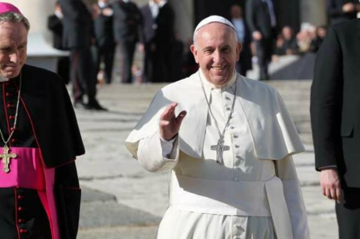 Pope Francis greets pilgrims during his general audience.