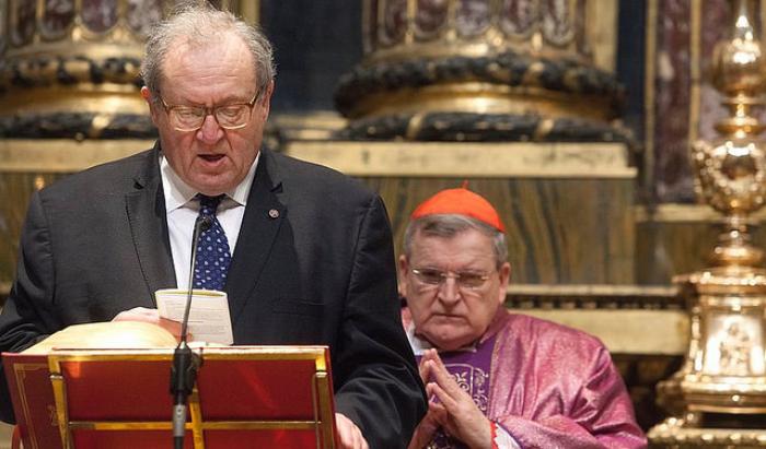 Grand Chancellor Michael Festing reads from the Bible as Cardinal Raymond Burke looks on. Cardinal Burke is Pope Francis' representative to the order.