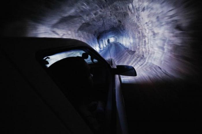 Workers descend through a mine shaft toward the caverns of Naica mine.