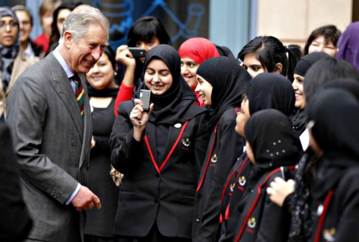 Prince Charles laughs with pupils as he leaves Belle Vue Girls School in Bradford, northern England.