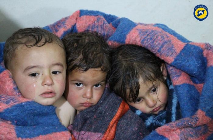 Child survivors are kept warm following the attacks.