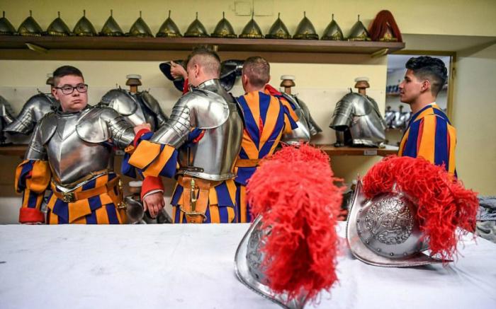 The new recruits also don helmets with scarlet ostrich plumage as they join the 500-year old army, first created by Pope Julius II in 1506.