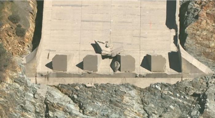 Fig 15. Large Block of concrete at the end of the spillway after the blowout failure. Block originated near (just above) the blowout failure critical seam. Shadow reveals the significance of the thickness of this block.