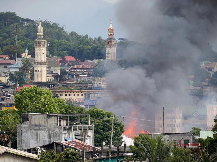 A structure that was once a strongpoint for terrorists burns in Marawi following an airstrike. The military continues to crush the terrorists, although slowly and methodically. 