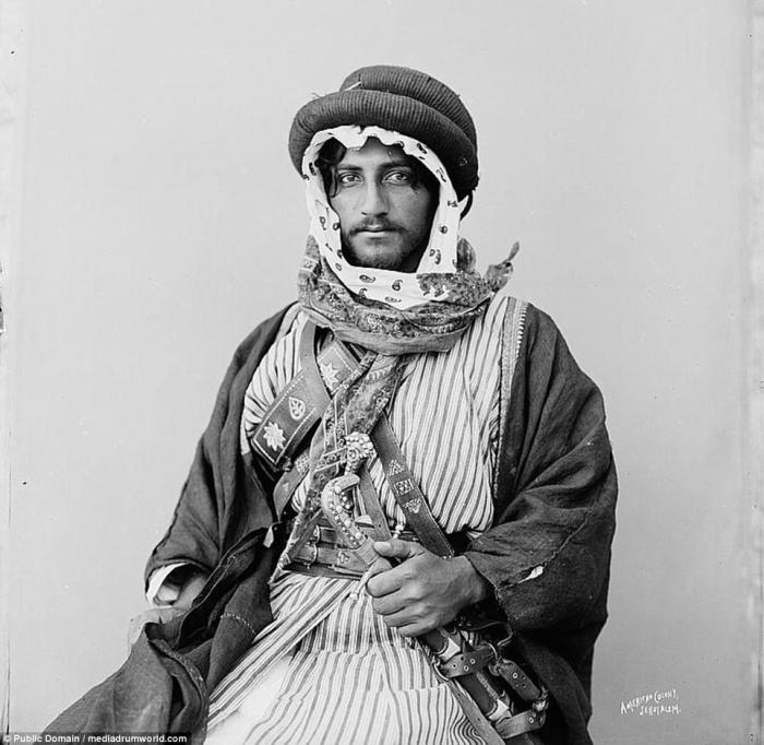 A young Bedouin man poses for the camera. The Bedouin still live from North Africa to the Middle East, but move less freely in the modern world. 