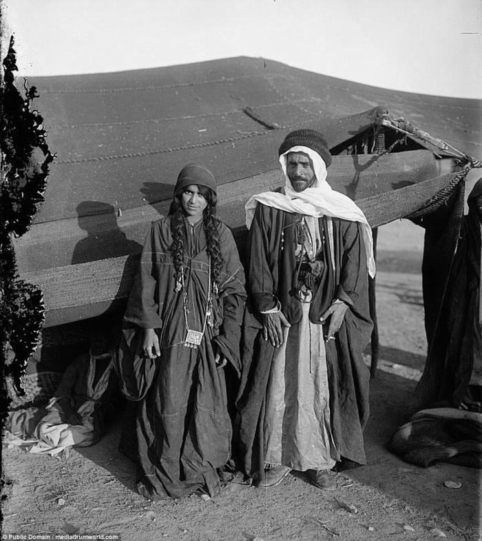 A Bedouin man and his wife pose in front of their tent. Today, Bedouin tents contain a few more modern luxuries. In some places, tourists can spend the night in such tents. 