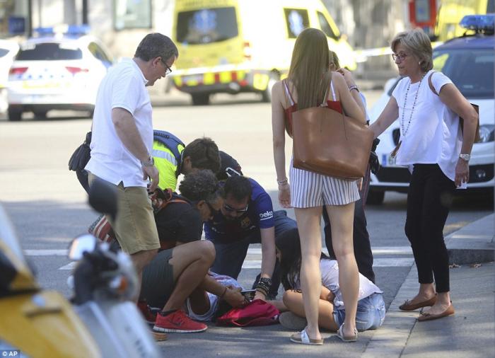 Bystanders rush to aid the injured. Bystanders rush to aid the injured.