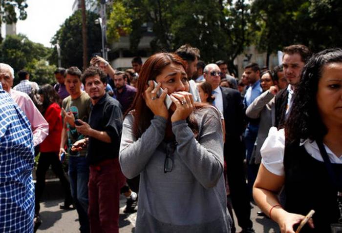 An emotional woman speaks on a cellphone in the aftermath of the quake. Earlier in the day, the city held earthquake drills on the anniversary of the 1985 quake which killed thousands.