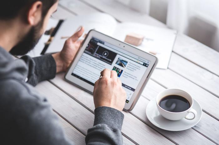 Man reading news on a tablet