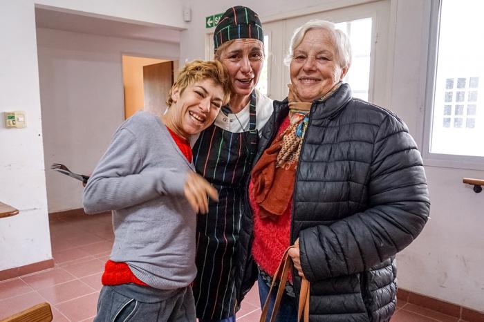 Graciela Ferrari (left) regularly visits Centro de Dia, a center run by local nonprofit Fundacion IPNA. She has befriended Sonia Trabichet (center), a cook, and comes to the center with her mother, Beatriz Rueco (right). Graciela Ferrari (left) regularly visits Centro de Dia, a center run by local nonprofit Fundacion IPNA. She has befriended Sonia Trabichet (center), a cook, and comes to the center with her mother, Beatriz Rueco (right).