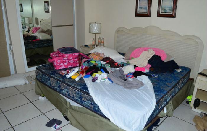 Clothes and toiletries are scattered across a bed where Guzman was found with an unidentified woman. Clothes and toiletries are scattered across a bed where Guzman was found with an unidentified woman.