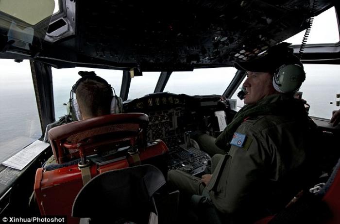 Royal Australian Air Force Flight Engineer Warrant Officer Ron Day keeping watch for any debris or w Royal Australian Air Force Flight Engineer Warrant Officer Ron Day keeping watch for any debris or w