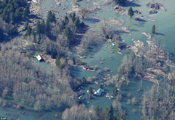 Houses and other structures are shown flooded by the backed-up Stillaguamish River up-river from the Houses and other structures are shown flooded by the backed-up Stillaguamish River up-river from the