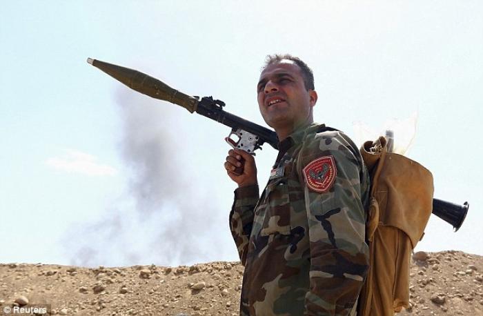 A member of the Kurdish peshmerga takes his position holding a rocket-propelled grenade launcher dur A member of the Kurdish peshmerga takes his position holding a rocket-propelled grenade launcher dur