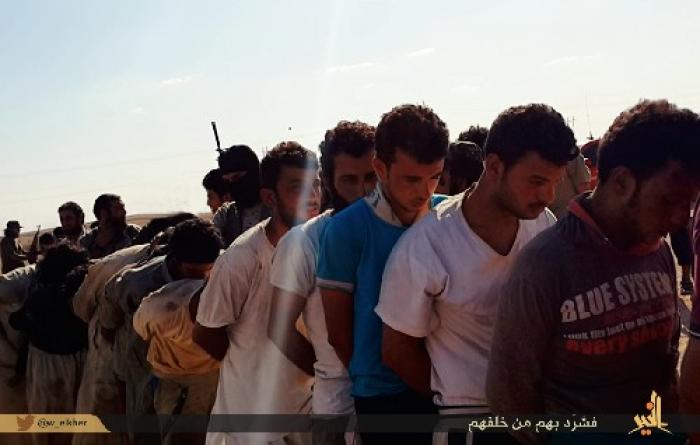 Captured Sunni tribesmen, accused of disloyalty are marched, barefoot in 120 degree heat, to their d Captured Sunni tribesmen, accused of disloyalty are marched, barefoot in 120 degree heat, to their d