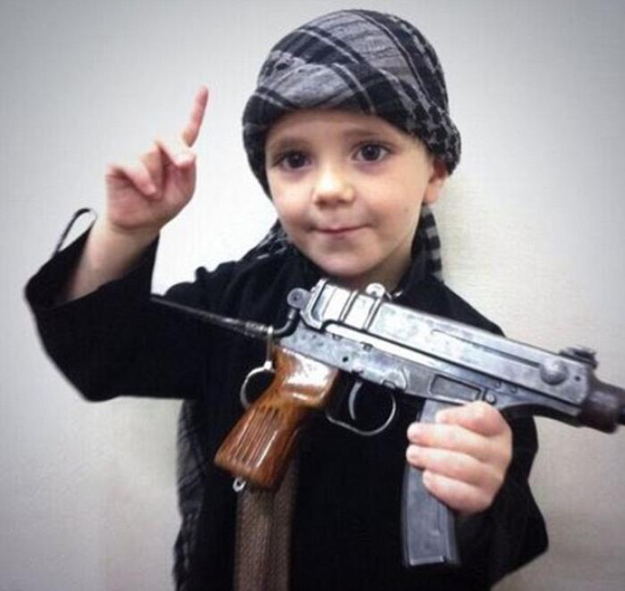 A child is poses with a weapon for ISIS propaganda. These people have no scruples, no inhibitions. F A child is poses with a weapon for ISIS propaganda. These people have no scruples, no inhibitions. F