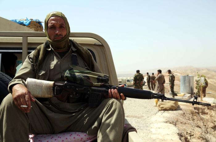 A member of the Kurdish Peshmerga troops sits in a vehicle as they secure an area in the town of Sul A member of the Kurdish Peshmerga troops sits in a vehicle as they secure an area in the town of Sul