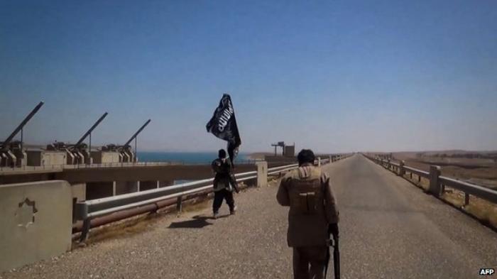 The black flags of jihadist group Islamic State flew over the Mosul dam for 10 days before it was re The black flags of jihadist group Islamic State flew over the Mosul dam for 10 days before it was re