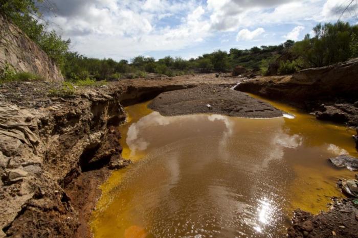 The leak likely stemmed from defects in newly built holding ponds at the mine. The leak likely stemmed from defects in newly built holding ponds at the mine.