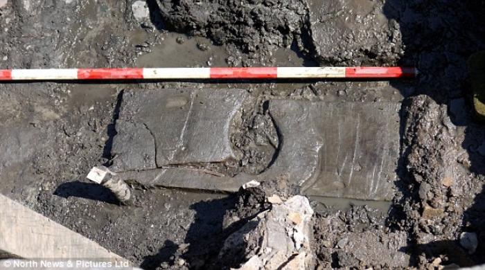 Dr. Andrew Birley discovered the toilet seat in a muddy trench (pictured) which was previously fille Dr. Andrew Birley discovered the toilet seat in a muddy trench (pictured) which was previously fille