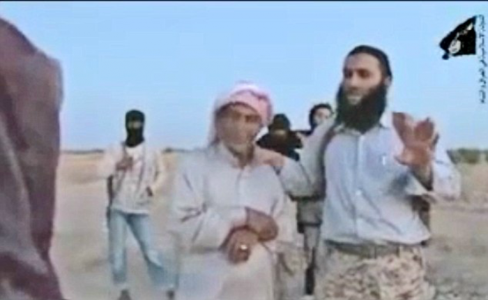 The bearded ISIS militant orders the woman to be 'content and happy' that she is about to be stoned The bearded ISIS militant orders the woman to be 'content and happy' that she is about to be stoned