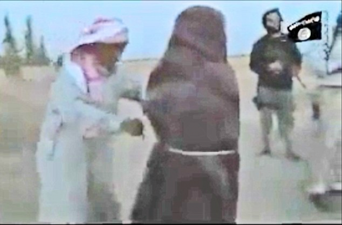 As the militants rain down rocks on the defenseless woman, her father (left) steps forward and picks As the militants rain down rocks on the defenseless woman, her father (left) steps forward and picks