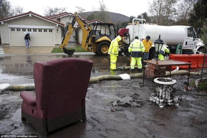 A chair is seen in a damaged front yard as crews work to channel mudflows in the area of the 2013 Sp A chair is seen in a damaged front yard as crews work to channel mudflows in the area of the 2013 Sp