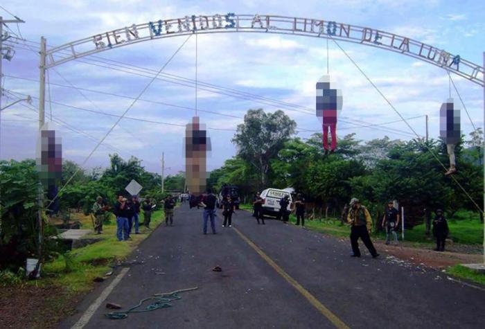 The body of a pregnant woman and three other residents were hung in 2013 from the welcome sign to ru The body of a pregnant woman and three other residents were hung in 2013 from the welcome sign to ru