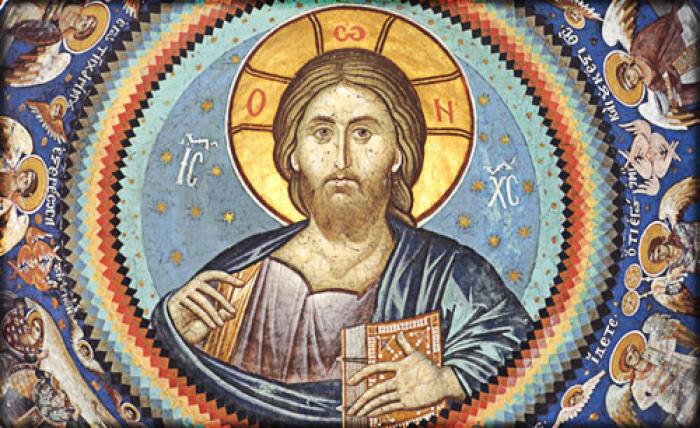The halo is a sign of divinity. The Greek letters tell us who is depicted in the image. In this case, Jesus is present with a Bible, representing the Word of God made flesh.